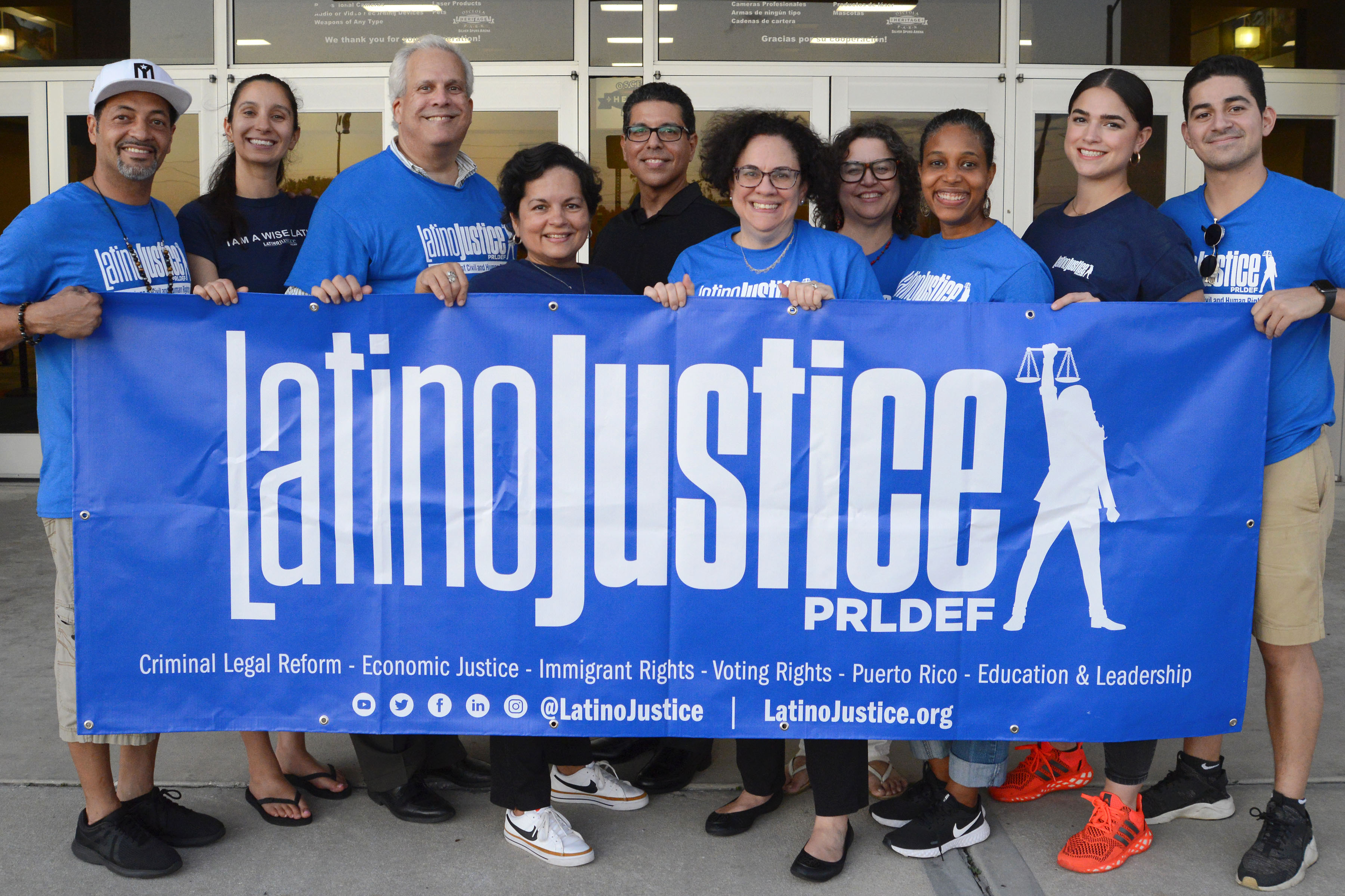 Image of LatinoJustice Leadership team holding a LatinoJustice blue banner